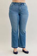 Medium-wash blue judy blue mid rise slim bootcut jeans with high-rise fit and flared legs for plus size wear