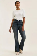 High-waisted dark wash denim judy blue jeans with flared leg and distinctive frayed hem detail