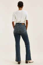 Dark blue denim judy blue jeans with classic back pocket design and frayed hem visible from the back side