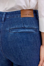 Blue denim judy blue high waist flare jeans with brown leather brand patch and front patch pockets at waistband