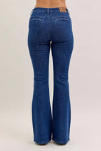 Judy Blue high waist flare jeans in blue denim with front patch pockets and a brown leather brand tag at the waistband