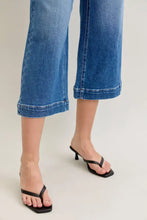 Black square toe heeled flip flops paired with judy blue mid rise crop wide leg jeans in a casual look