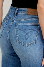 Back view of blue denim judy blue mid rise crop wide leg jeans with brown leather patch on waistband