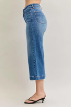 Blue denim capri pants with rolled cuffs and classic five-pocket design in judy blue mid rise crop wide leg jeans style