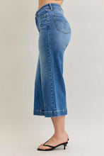 Blue denim culottes with high waist and wide leg cut featuring classic five-pocket design in judy blue mid rise style