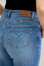 Back side of judy blue mid rise crop wide leg blue denim jeans with heart stitch and brown leather judy blue patch
