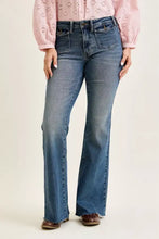 Judy blue mid rise flare jeans in blue denim with classic five-pocket design and frayed hems featuring front flap pockets