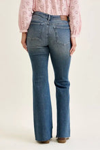 Judy blue mid rise flare jeans in blue denim with classic five-pocket design and frayed hems featuring front flap pockets