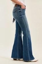 Blue denim jaqueline flare jeans with a mid rise, classic five-pocket design, brown leather waistband, and bandana loop