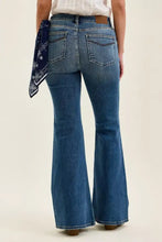 Blue denim jaqueline flare jeans with classic five-pocket design and brown leather waistband shown from the back side