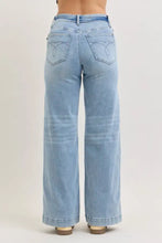 Back side of judy blue mid rise retro wide leg light-wash denim jeans with fold-over waistband and embroidered heart pockets