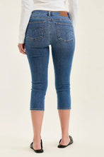 Blue denim judy blue mid-rise stretch capri jeans with classic five-pocket design and brown leather waistband patch
