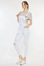 Kancan distressed skinny denim overalls with white distressed finish and light brown t-shirt