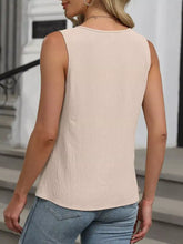 Beige keyhole neck tank top in subtle textured fabric with rounded neckline sleeveless design