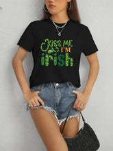 Black Kiss Me Im Irish crewneck t-shirt with green shamrock text, short sleeve