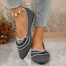 Pair of black and white point toe flats with ruffled accents and anklet