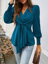 Teal satin knot front lantern sleeve blouse with v-neck, long puffed sleeves, and tied waist detail