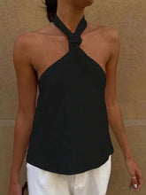 Black halter neck cami with knotted halter neckline and relaxed fit perfect for casual wear