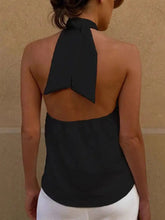 Black halter neck cami with knotted halter design featuring a flowing tied bow at the back side of the top