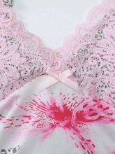 Pink lace-trimmed leopard cami with a ruched bodice and vibrant floral print featuring a satin bow neckline