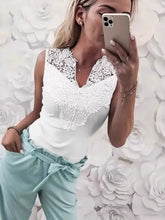 White sleeveless notched tank features lace trim and soft fabric with a v-neckline for elegant comfort