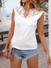 White sleeveless notched tank features lace detailing across the neckline and front for an elegant look