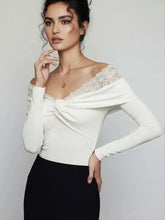 White off-the-shoulder long sleeve bodysuit featuring lace detail and a draped front knot design