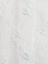 White lace detail ruffle sleeve button up shirt showing subtle textured fabric with two matching white buttons