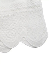 White lace shorts with intricate floral patterns and scalloped hem paired with lace detail ruffle sleeve button up shirt