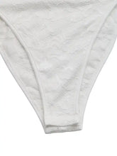 White lace thong with delicate floral patterns and seamless finish as part of lace frill strap bodysuit collection