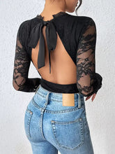 Black lace long sleeve bodysuit showing back side with bow detail highlighting lace long sleeve design