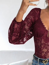A maroon lace long sleeve bodysuit with deep v-neckline and puffed three-quarter sleeves in lace material