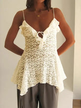 Off-white lace ruffle trim camisole with thin spaghetti straps, ruffled neckline, and flared hem in delicate lace fabric