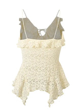 Cream-colored lace ruffle trim tie-front cami with delicate ruffled straps and a peplum hem design