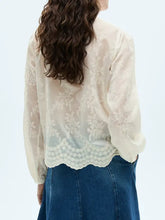 A delicate off-white lace sheer long blouse with intricate floral embroidery and scalloped hem in lace sheer long sleeve design