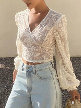 Ivory lace sheer long sleeve crop top with floral embroidery and delicate long sleeve wrap design