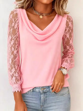 A soft pink lace sleeve cowl neck blouse featuring delicate lace sleeves and a scalloped hem for elegant wear