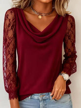 A maroon lace sleeve cowl neck blouse featuring sheer lace sleeves and a soft draped neckline