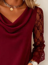 A deep burgundy lace sleeve cowl neck blouse with sheer lace sleeves for elegant and stylish wear