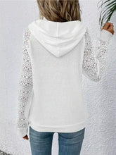 White lace sleeve kangaroo pocket hoodie with textured body made of slightly stretchy fabric and machine wash care instructions