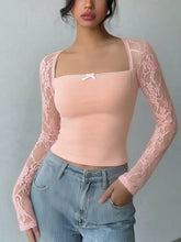 Delicate pink lace long sleeve top with a square neck and a small white bow at the center front