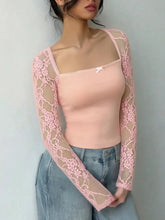 A delicate pink lace long sleeve top with a square neck and sheer floral detailing