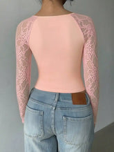 A soft pink long sleeve top with lace sleeve detailing and a square neck for elegant wear
