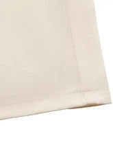 Cream-colored wide leg jumpsuit with lace trim belted design and neat hem stitching