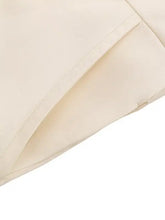 Cream-colored wide leg jumpsuit with lace trim belted design and precise stitching