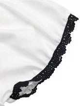 White satin skirt with delicate black lace trim along the hem paired with lace trim bowknot short sleeve blouse