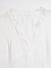 A delicate white lace trim notched blouse featuring intricate lace detailing along the neckline and front placket