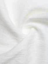 A soft white cotton lace trim notched blouse features lace trim with subtle texture and gentle folds