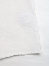 White cotton lace trim notched blouse featuring a subtle textured weave and neatly finished hem
