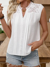 White sleeveless blouse features lace trim notched neckline and vertical pleats down the front for elegant wear